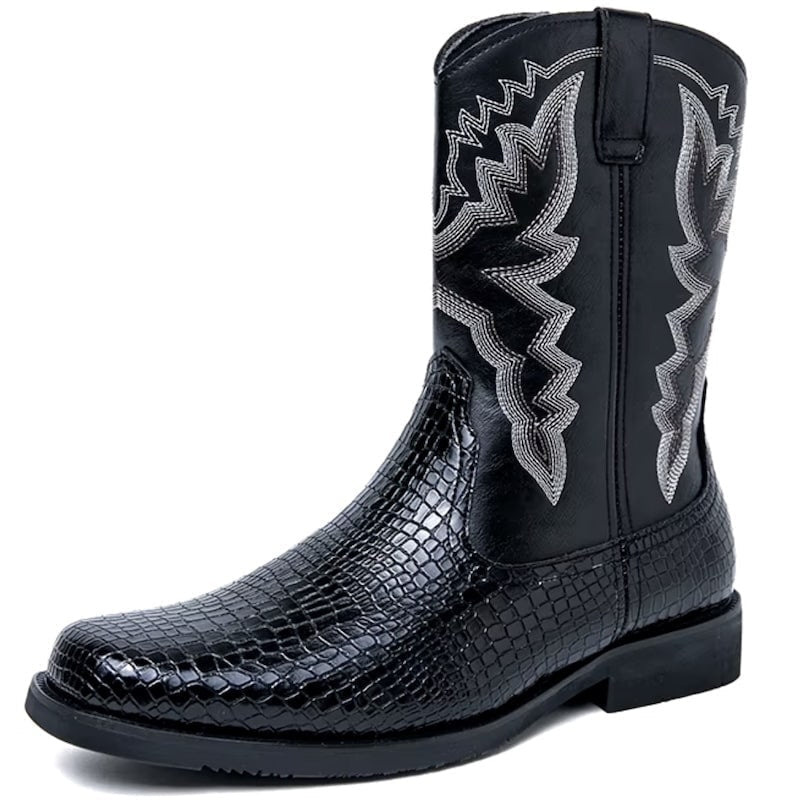 Black cowboy boot with reptile-print lower and decorative stitching.
