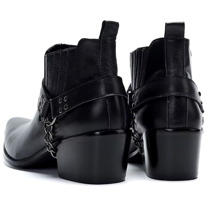 Two black leather Chelsea boots with harness straps.