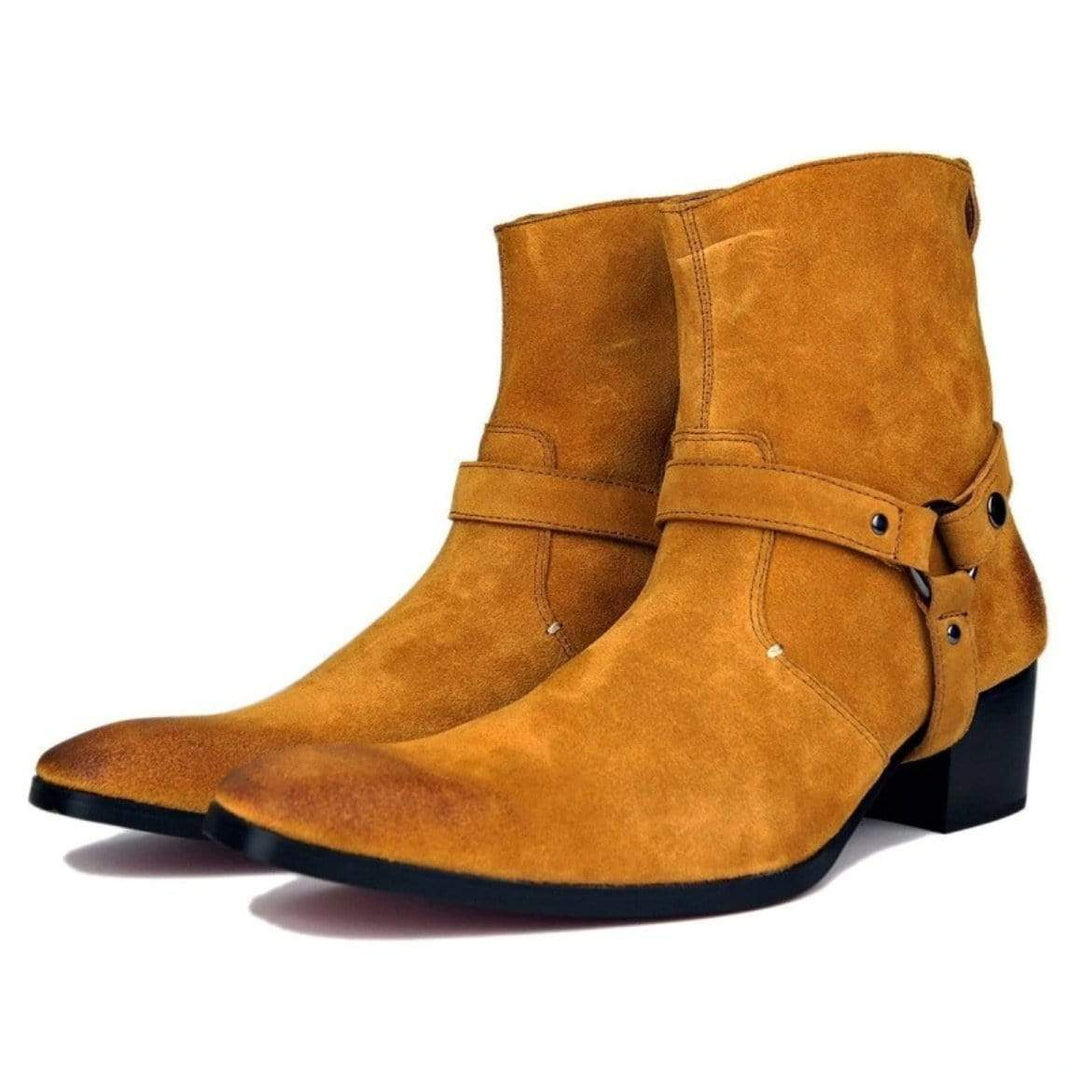 Two tan suede ankle boots with straps and black heels.