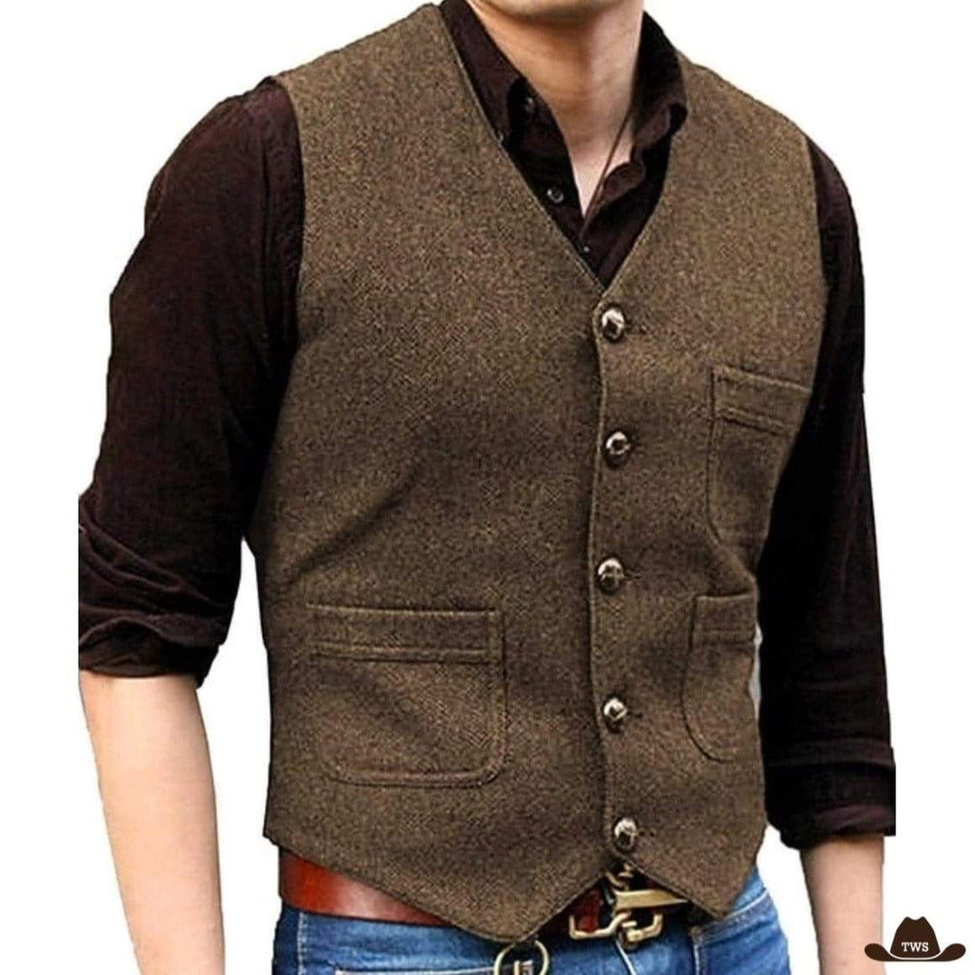 Man in brown tweed vest, brown shirt, and blue jeans.